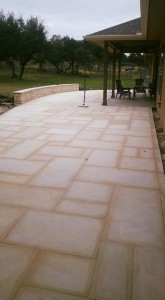 A patio with a white tiled floor and chairs.